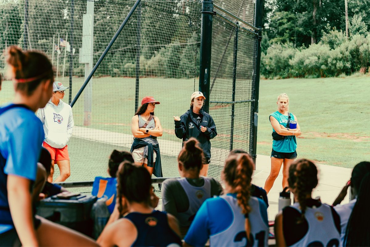 Style Lacrosse coaches teaching a group of seated athletes about the recruiting process